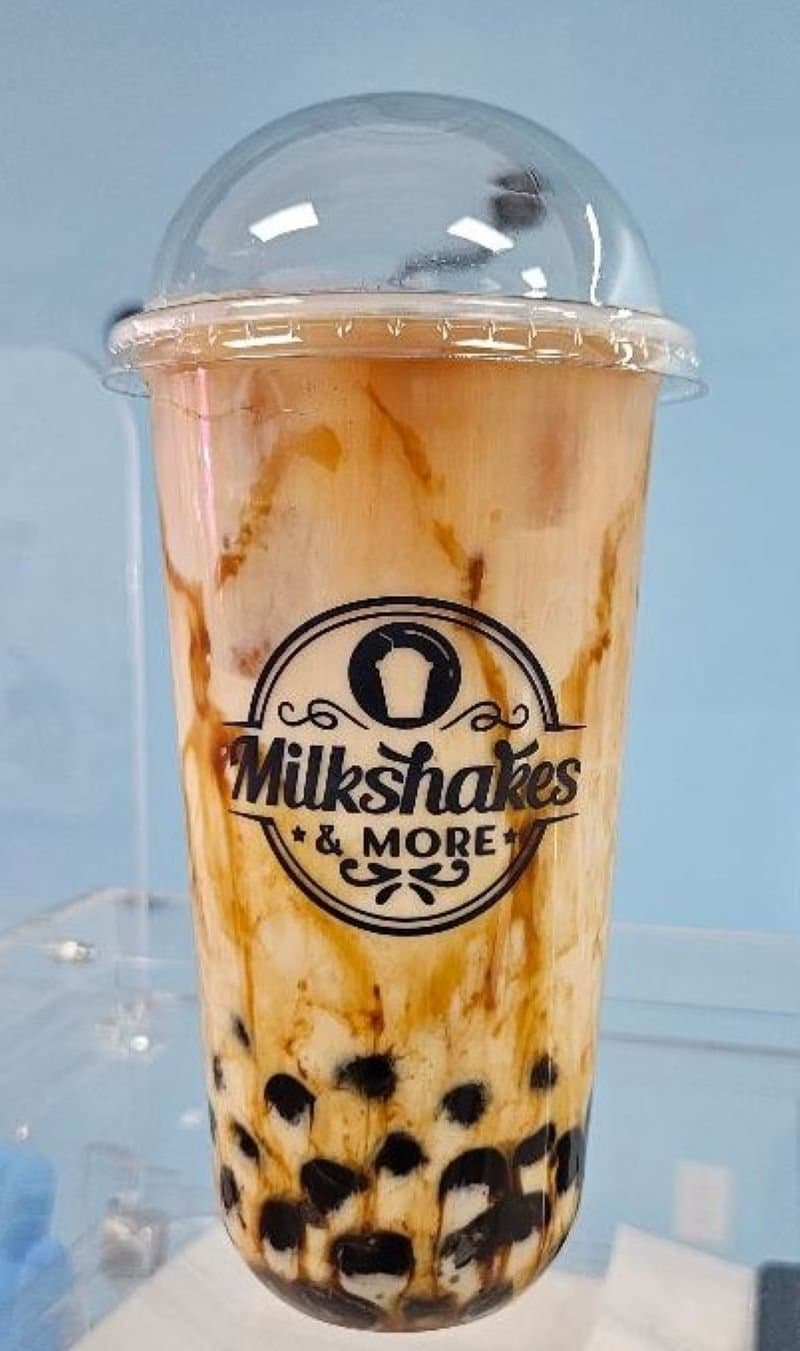 Brown sugar milk tea with boba in a Milkshakes & More cup