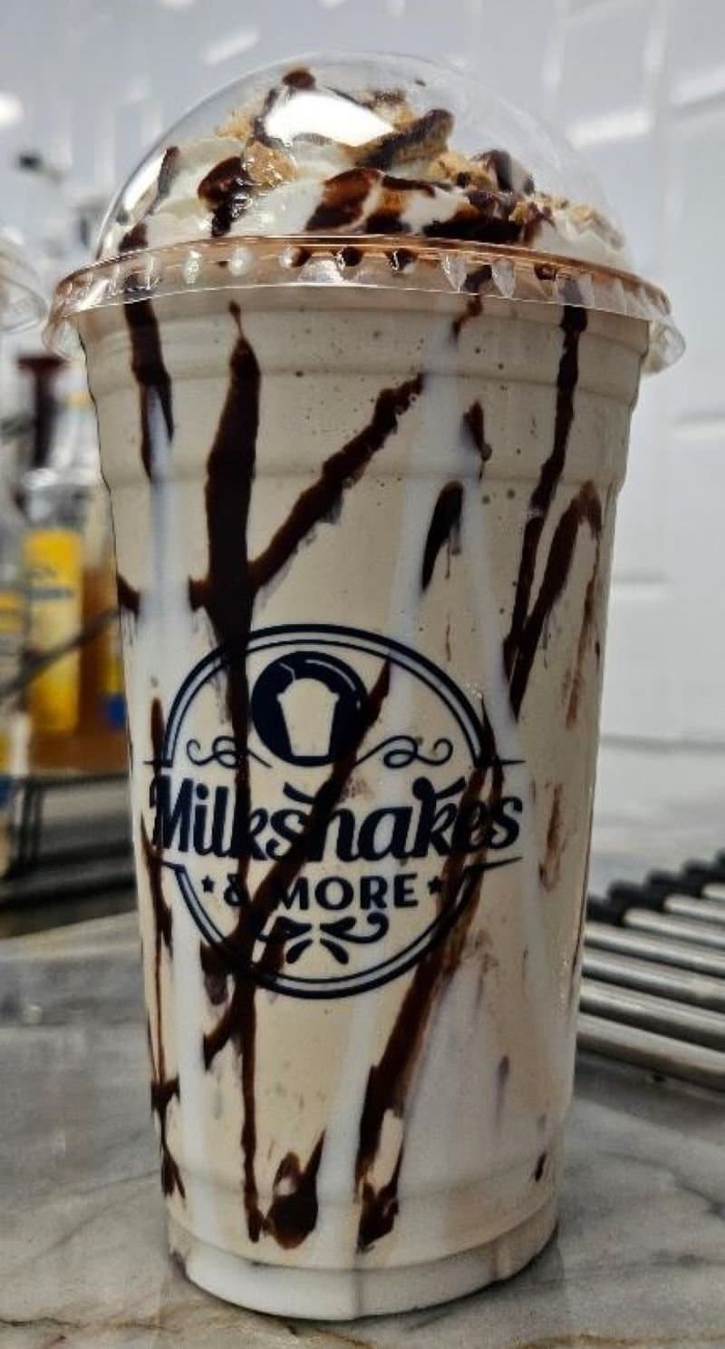 S’mores Campfire & Cocoa milkshake with chocolate drizzle in a Milkshakes & More cup